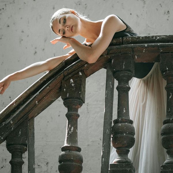 Person performing a gentle stretching exercise, embodying flexibility and grace.