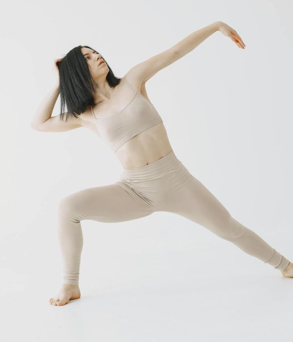 Woman in a calm, focused pose, suggesting gentle movement and well-being.